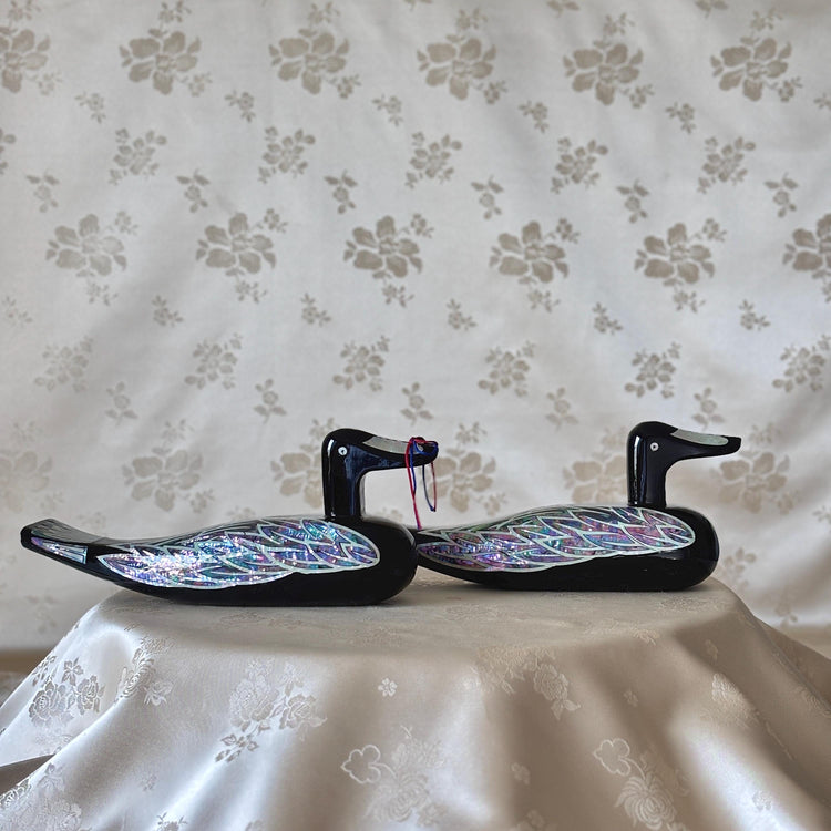 Large Korean mother-of-pearl wedding duck pair in black lacquer, displayed together on soft floral fabric