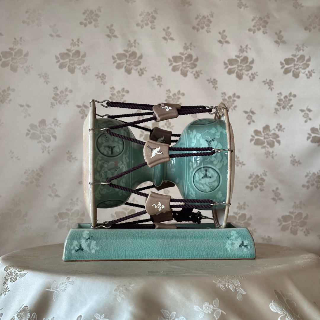 Decorative item with teal and silver design on a floral-patterned background Korean traditional