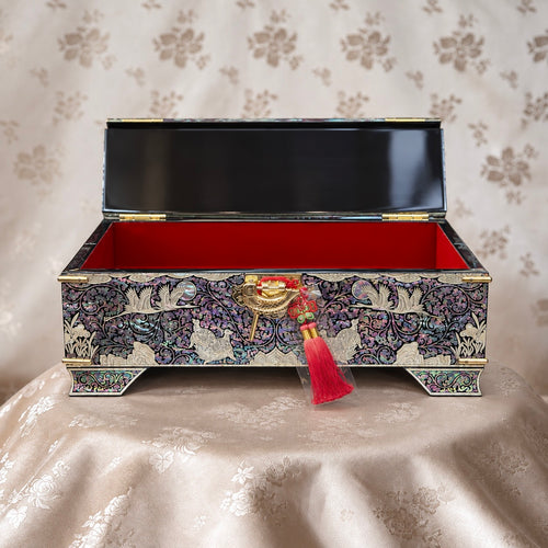 Chest with the lid open, showing the red interior