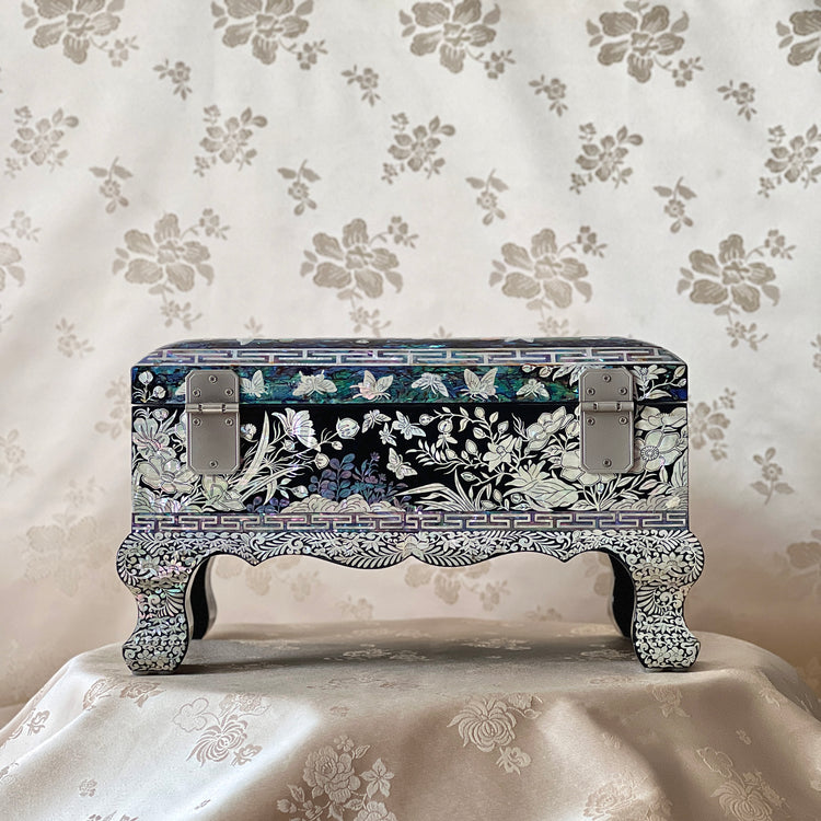 Back view of a Korean mother-of-pearl legged jewelry box with floral shell inlay and raised legs