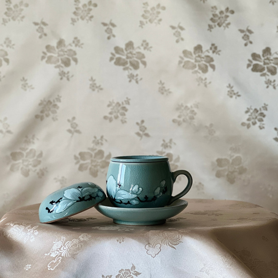 Celadon Tea Cup: Embossed Magnolia Motif