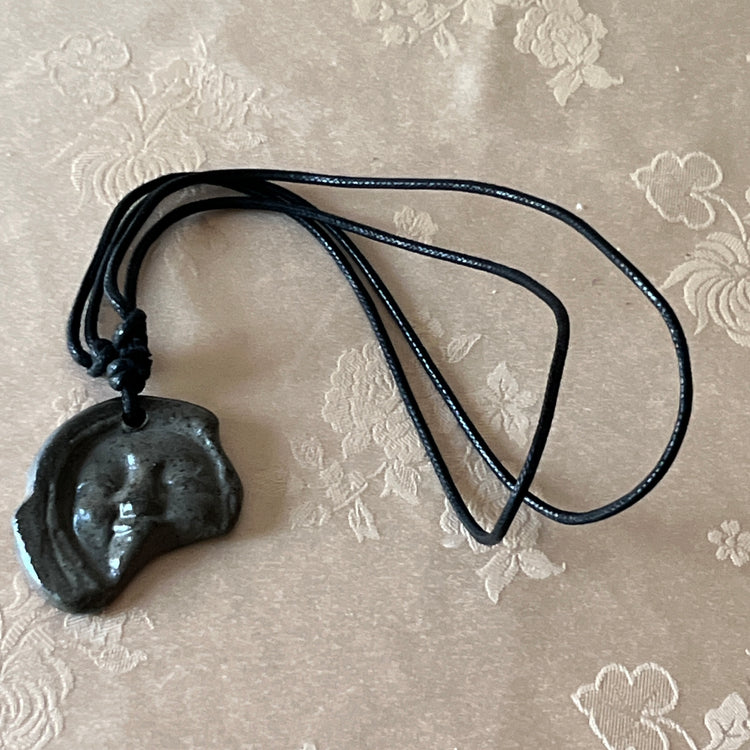 Korean Silla earthenware human-face Sumaksae pendant necklace with black cord