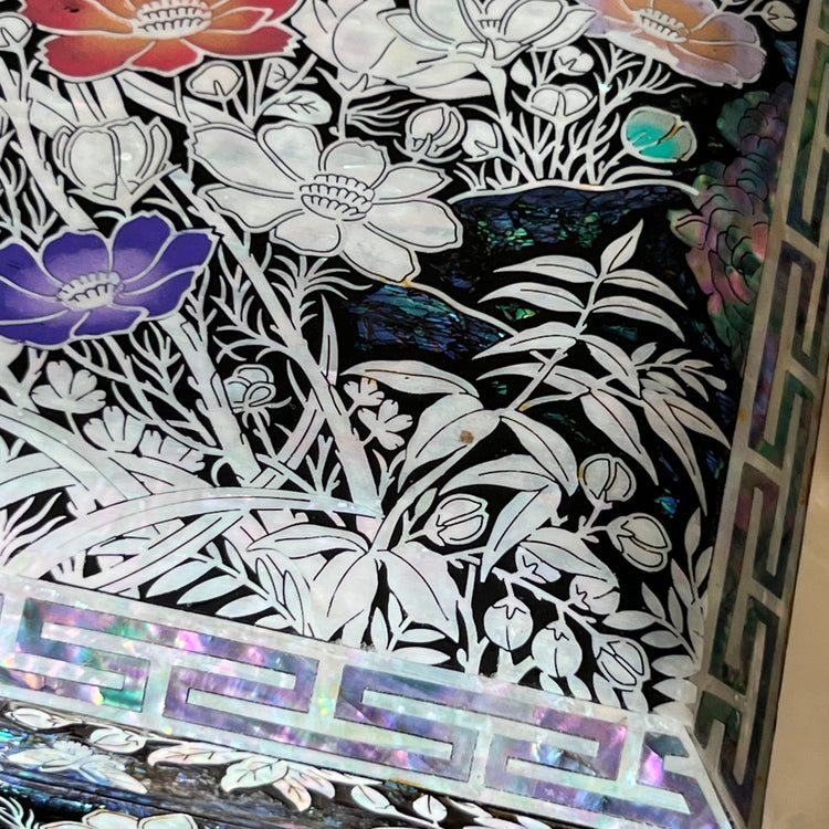 Close-up of floral mother-of-pearl inlay on the side of a Korean lacquer jewelry box