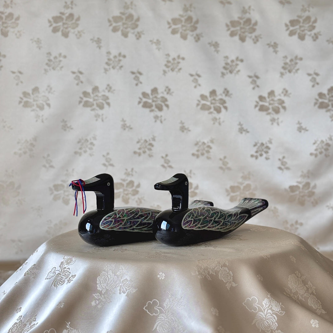 Large Korean black lacquer wedding duck pair shown from the side with mother-of-pearl wing inlay
