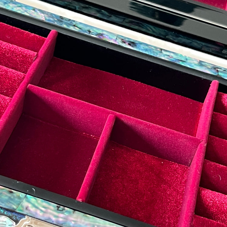 Close-up of red velvet storage compartments inside a Korean mother-of-pearl jewelry box