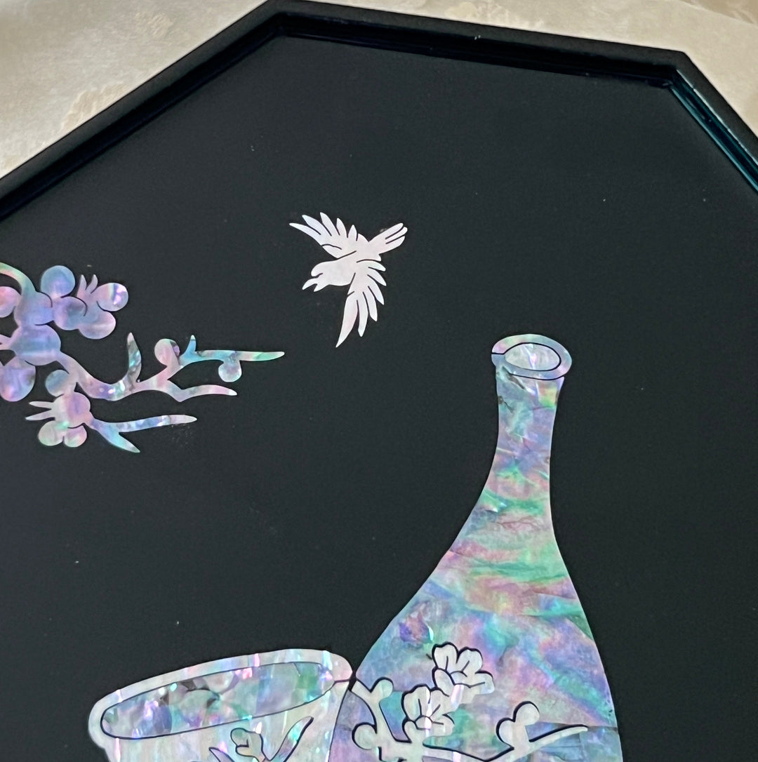 Close-up of mother of pearl crane and plum blossom inlay above vase on black lacquer Korean tray
