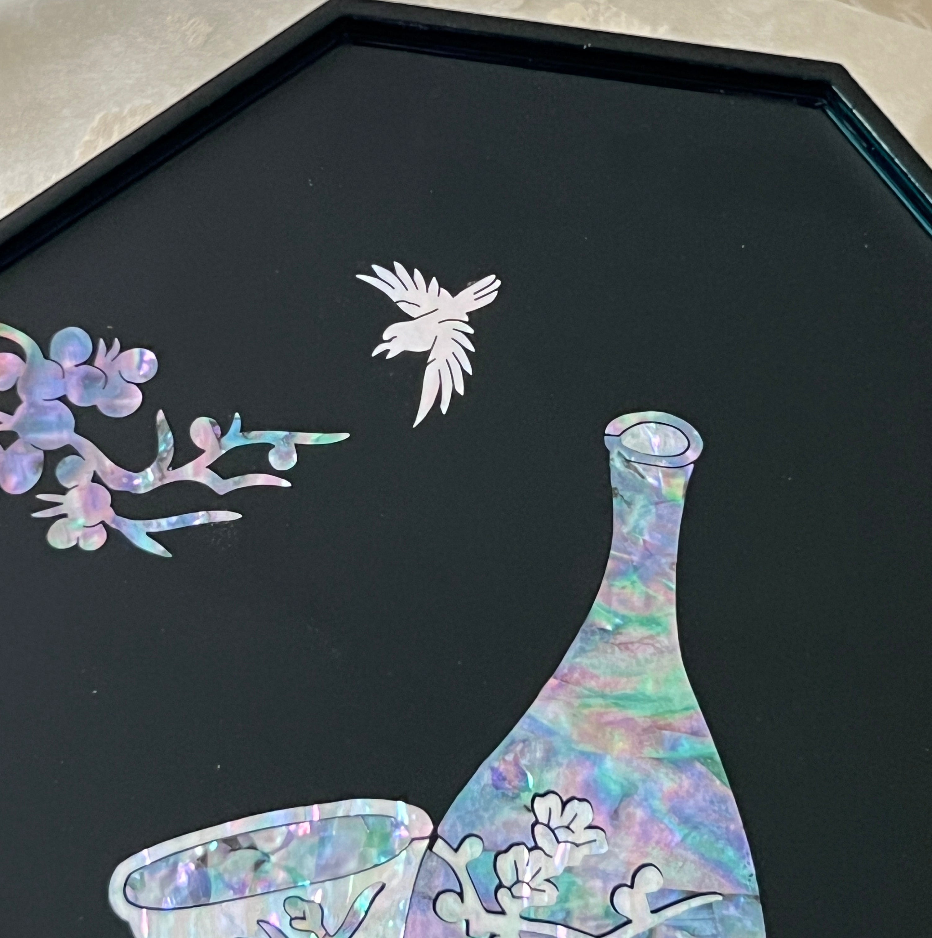 Close-up of mother of pearl crane and plum blossom inlay above vase on black lacquer Korean tray