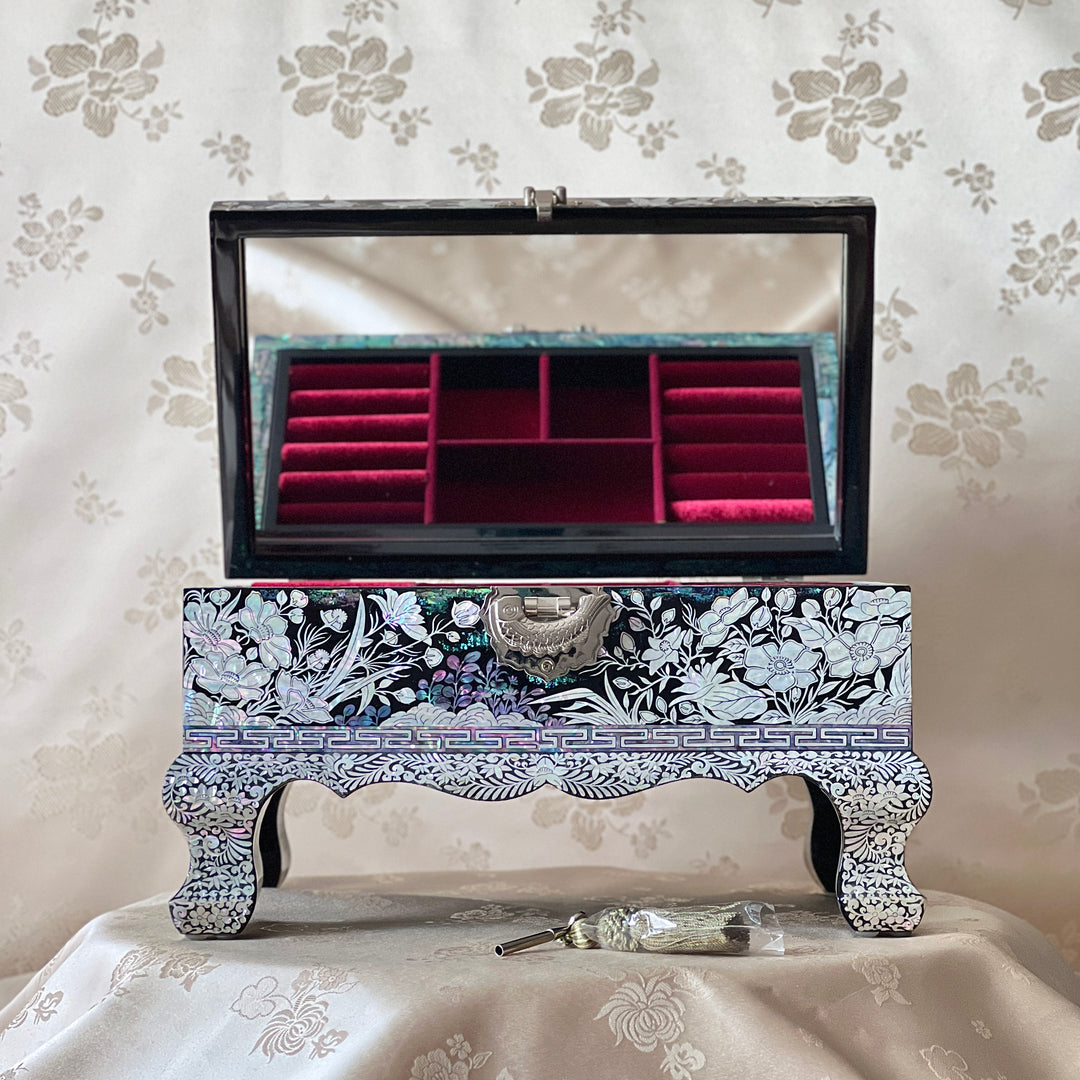 Open Korean mother-of-pearl jewelry box showing red velvet compartments and mirror inside the lid