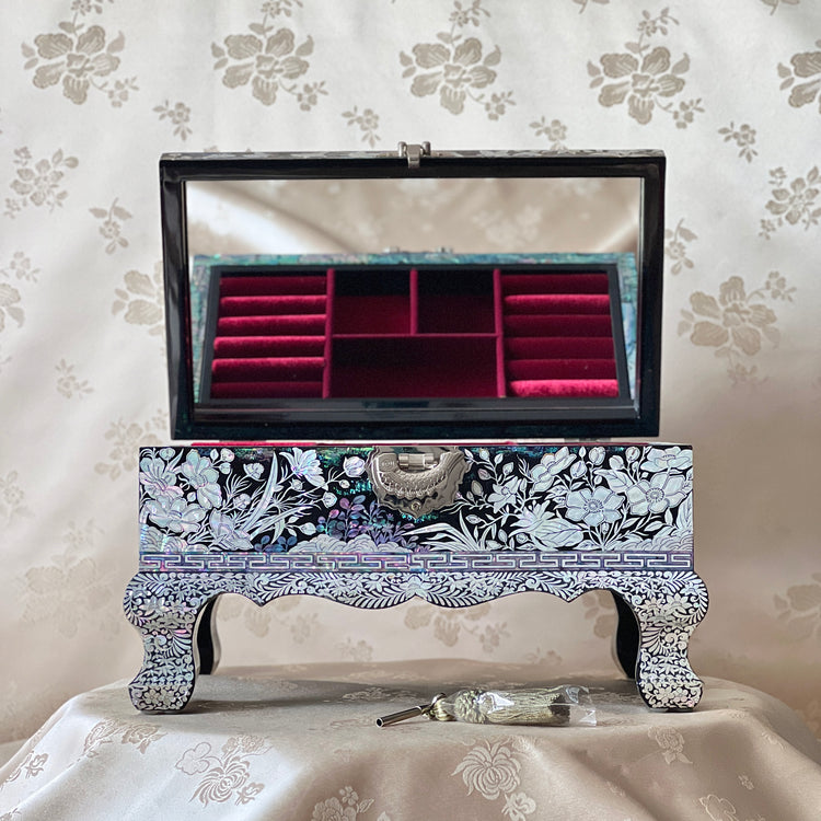 Open Korean mother-of-pearl jewelry box showing red velvet compartments and mirror inside the lid