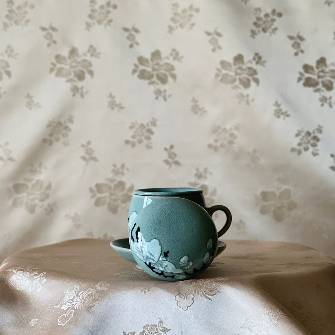 Celadon Tea Cup: Embossed Magnolia Motif