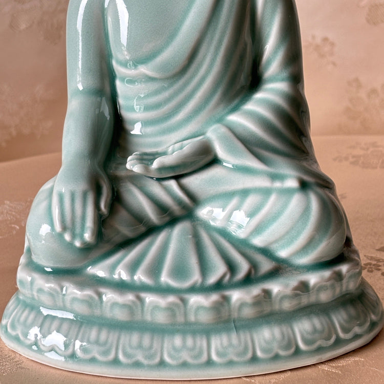 Korean handmade celadon pottery Buddha. Zoomin of hands and legs 