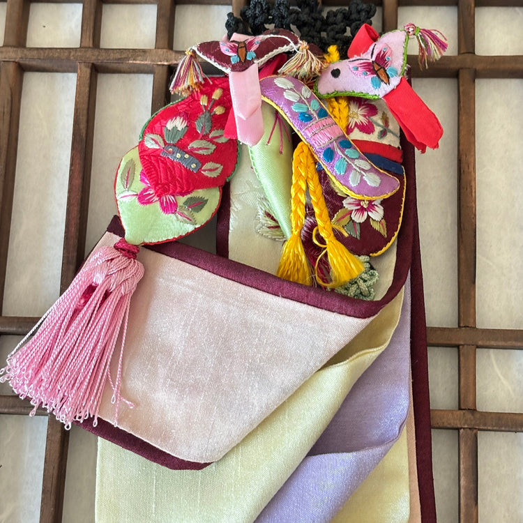 Traditional Korean hanbok with colorful patterns on a wooden lattice background