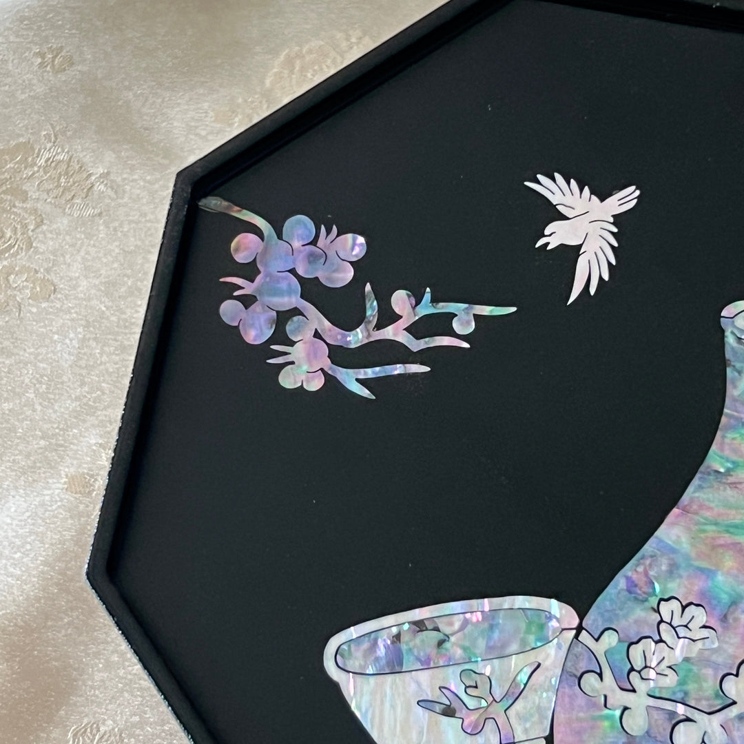 Close-up of mother of pearl crane and plum blossom inlay above vase on black lacquer Korean tray