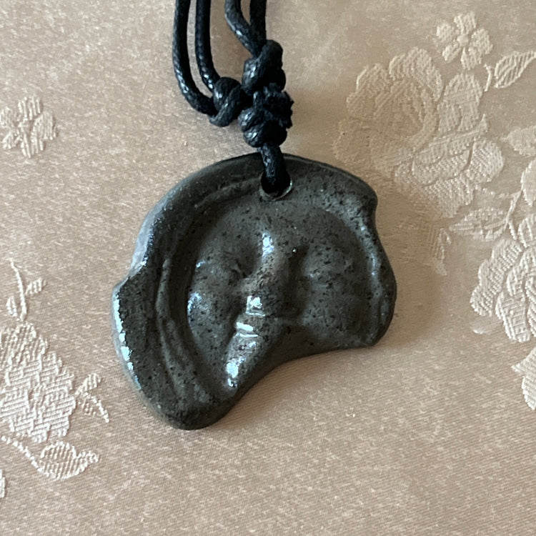 Korean Silla earthenware human-face Sumaksae pendant necklace with black cord
