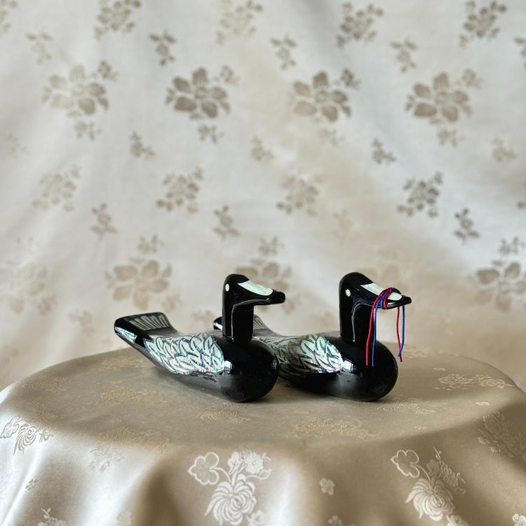 Pair of Korean mother-of-pearl wedding ducks with iridescent inlay on black lacquer bodies