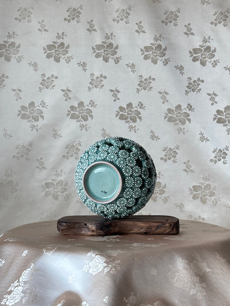 Decorative bowl on a floral-patterned surface