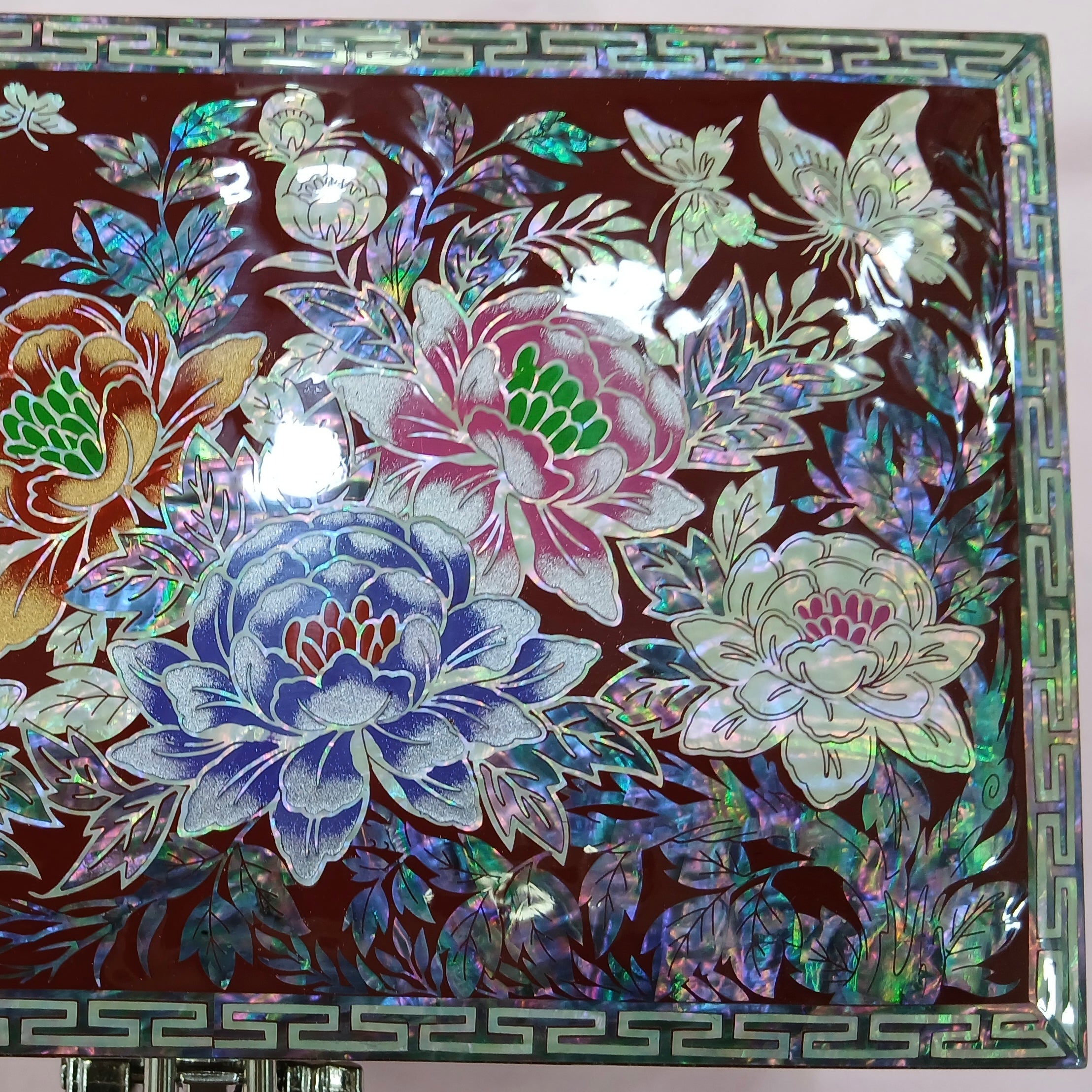 Decorative Korean box with floral and butterfly designs on a dark background