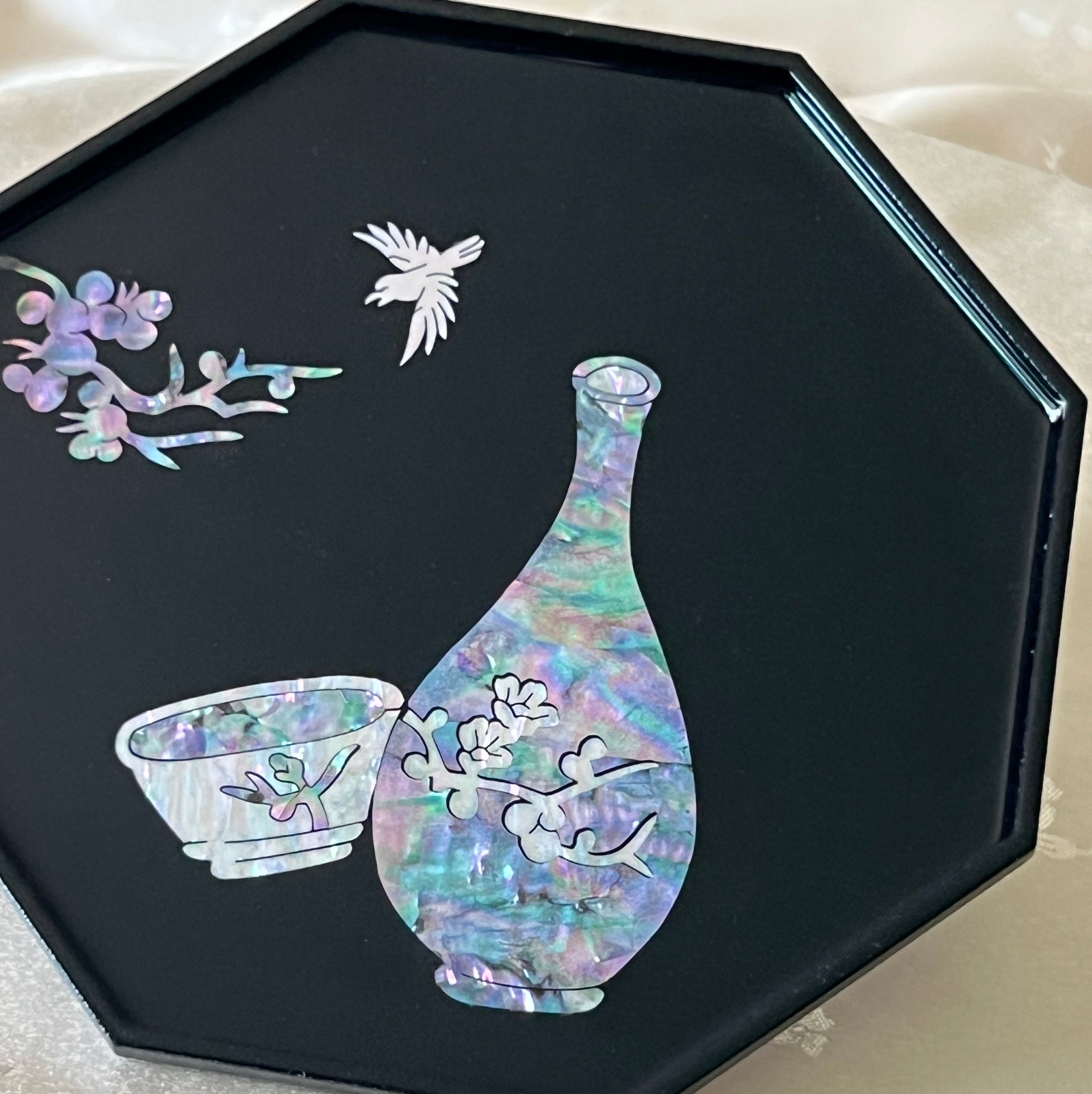 Iridescent mother of pearl vase and cup inlay on Korean black lacquer octagonal tray, detail view