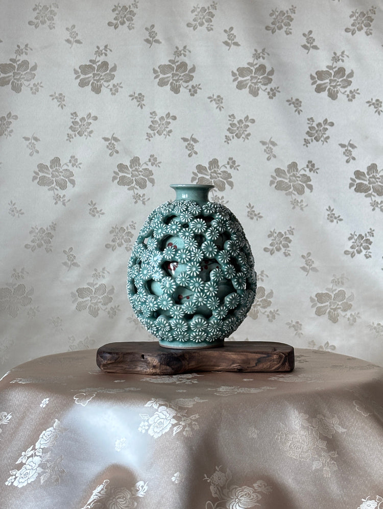 Decorative vase on a floral-patterned surface