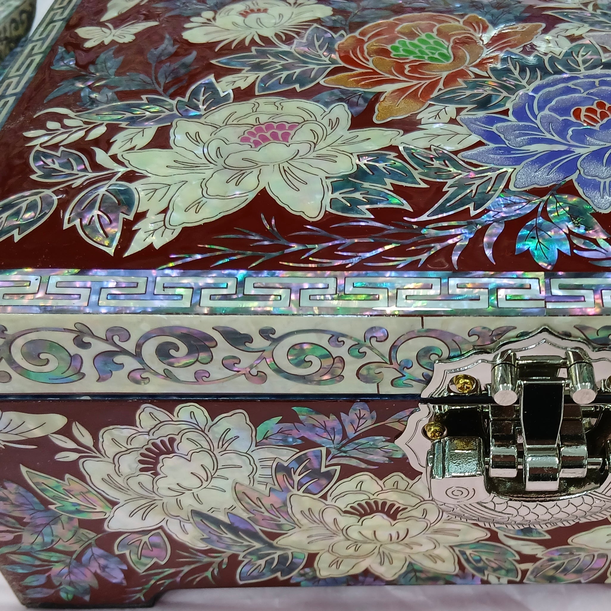 Decorative Korean jewelry box with floral patterns and a metallic clasp.