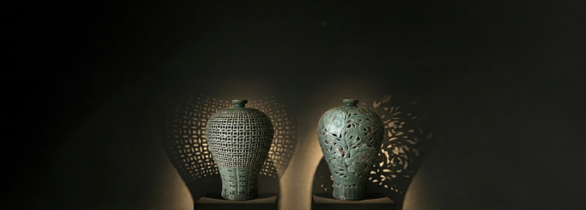 Three textured ceramic vases on a dark background
