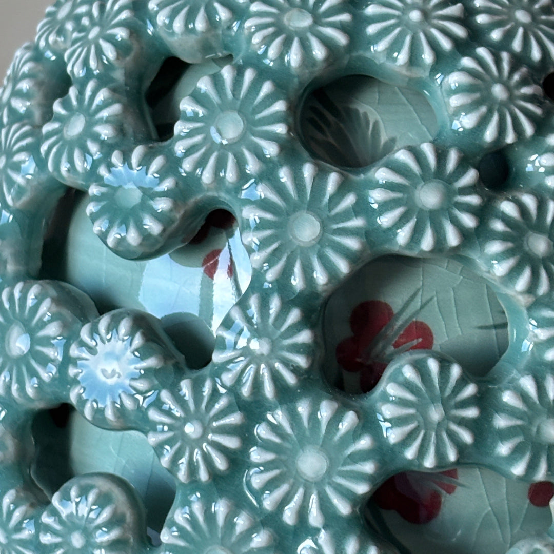 Ceramic vase with floral patterns and red accents