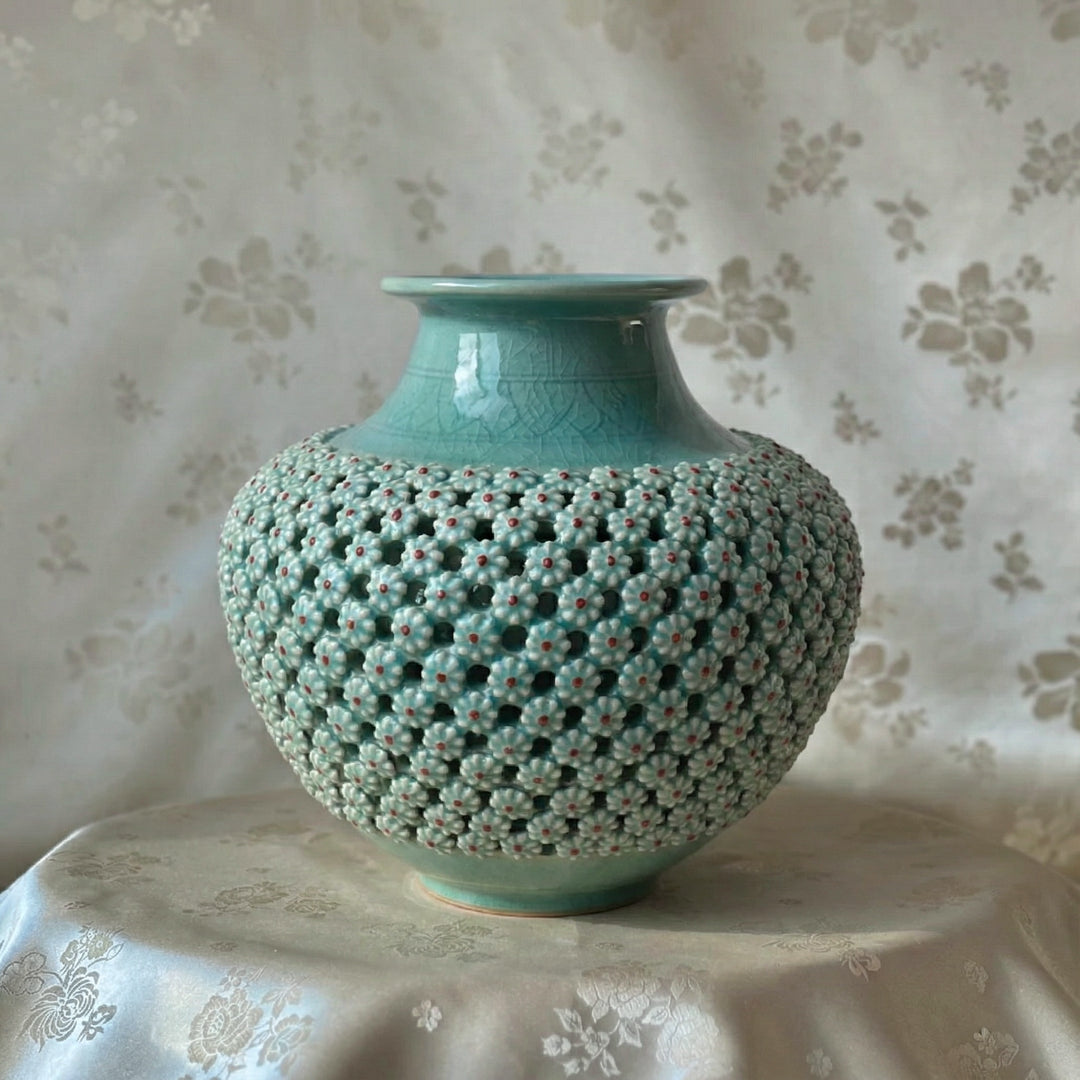 celadon jade ceramic vase with textured surface on a floral-patterned tablecloth from korea