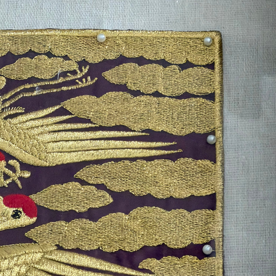 Embroidered fabric with gold leaf pattern on a purple background
