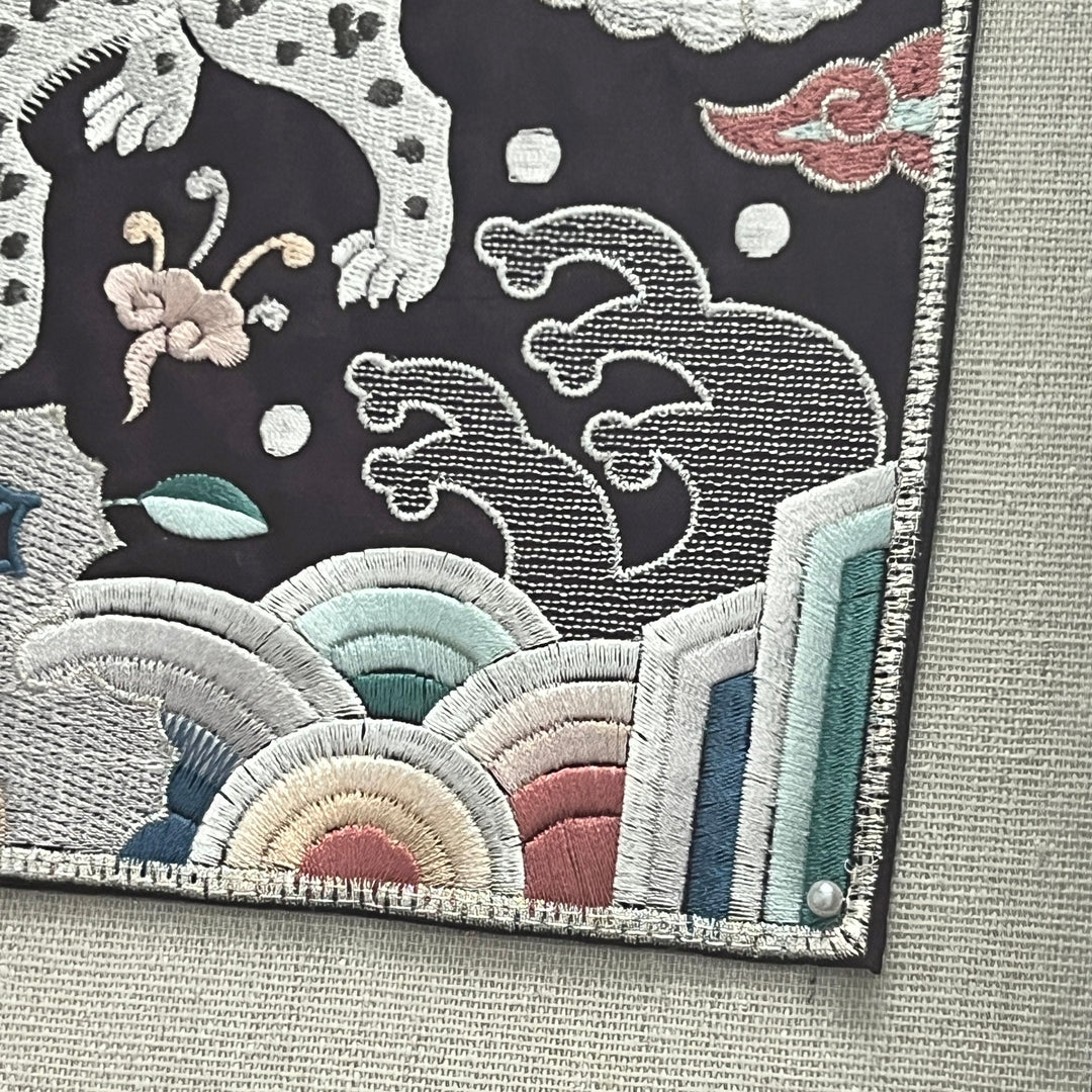 Embroidered patch with abstract design on a fabric background