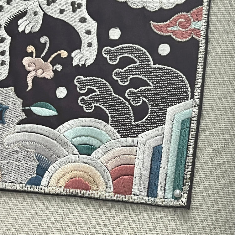Embroidered patch with abstract design on a fabric background