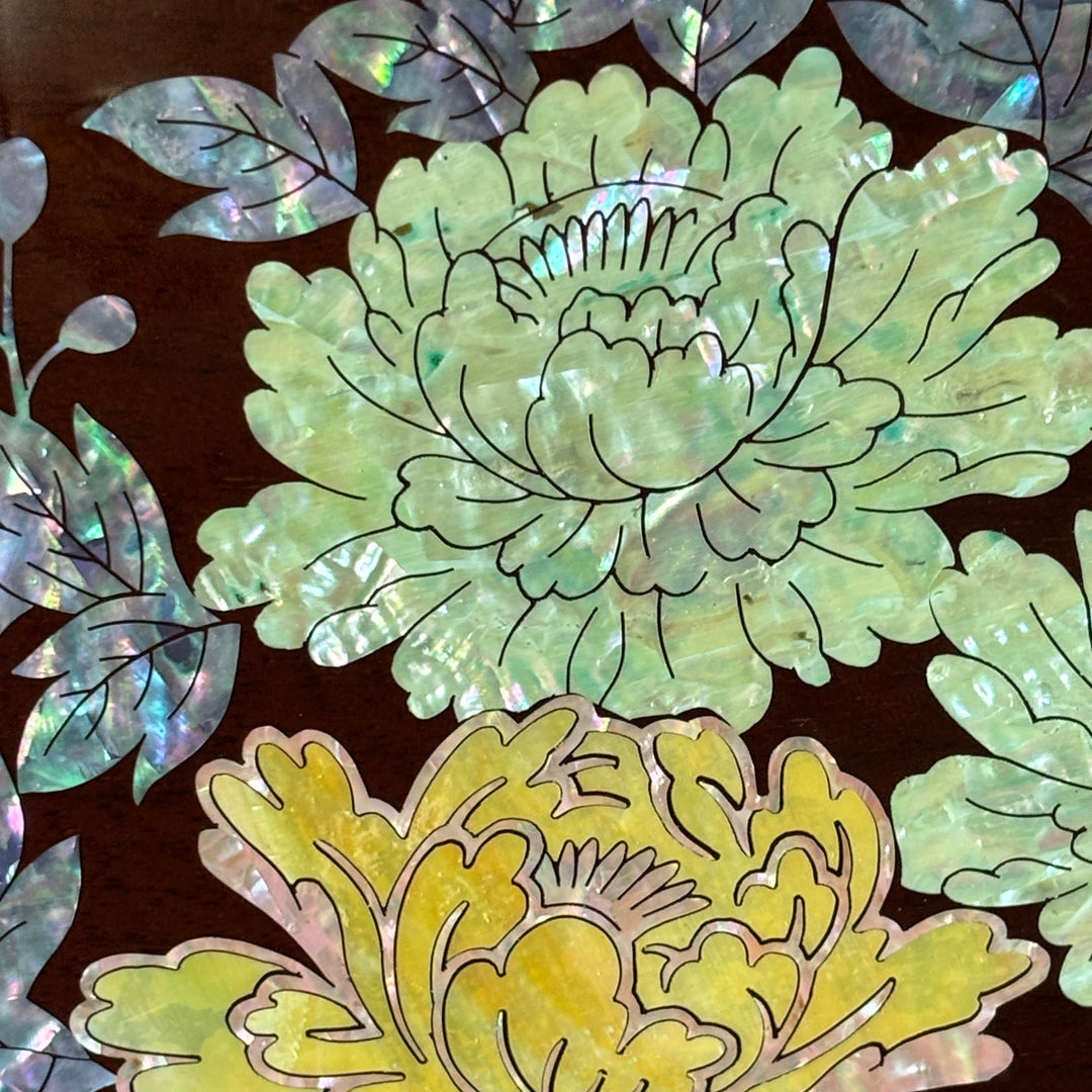 Decorative floral design with green and yellow flowers on a dark background