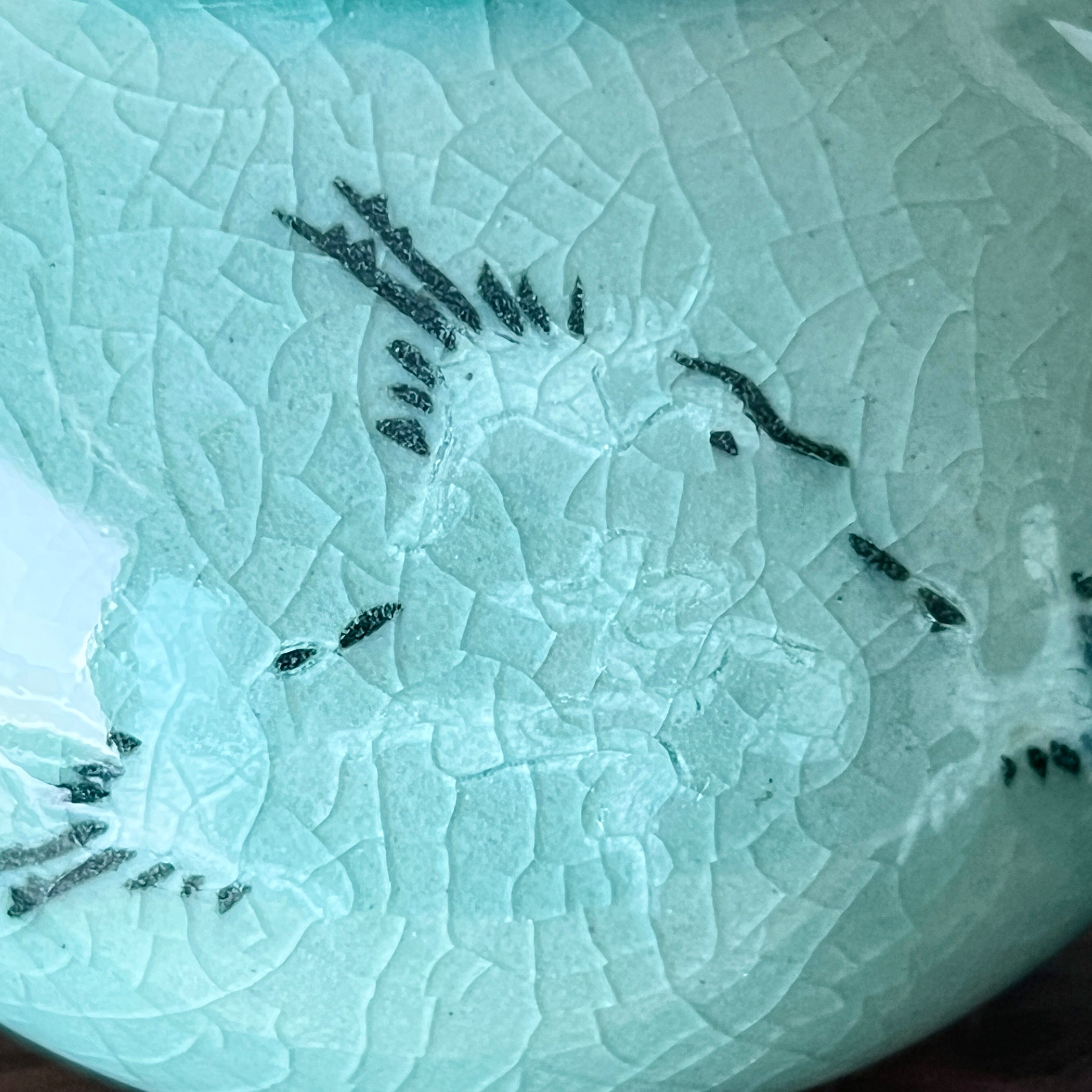 Close-up of a textured ceramic with crane pattern