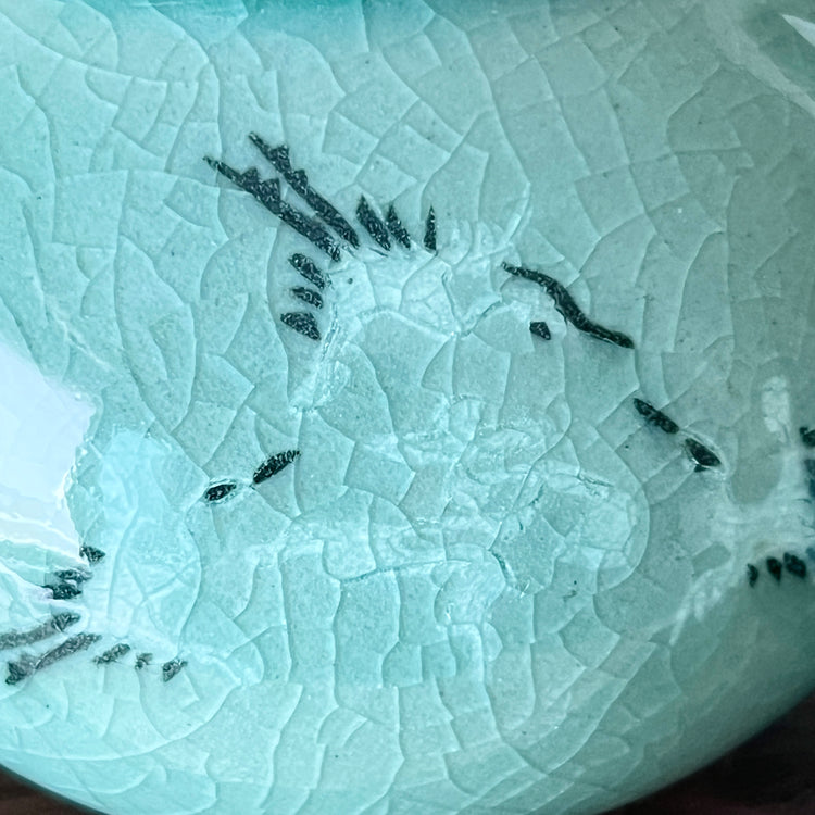 Close-up of a textured ceramic with crane pattern