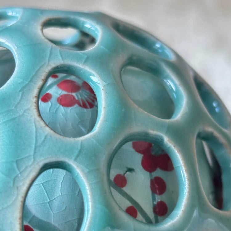 Ceramic dish with floral patterns on a light blue background