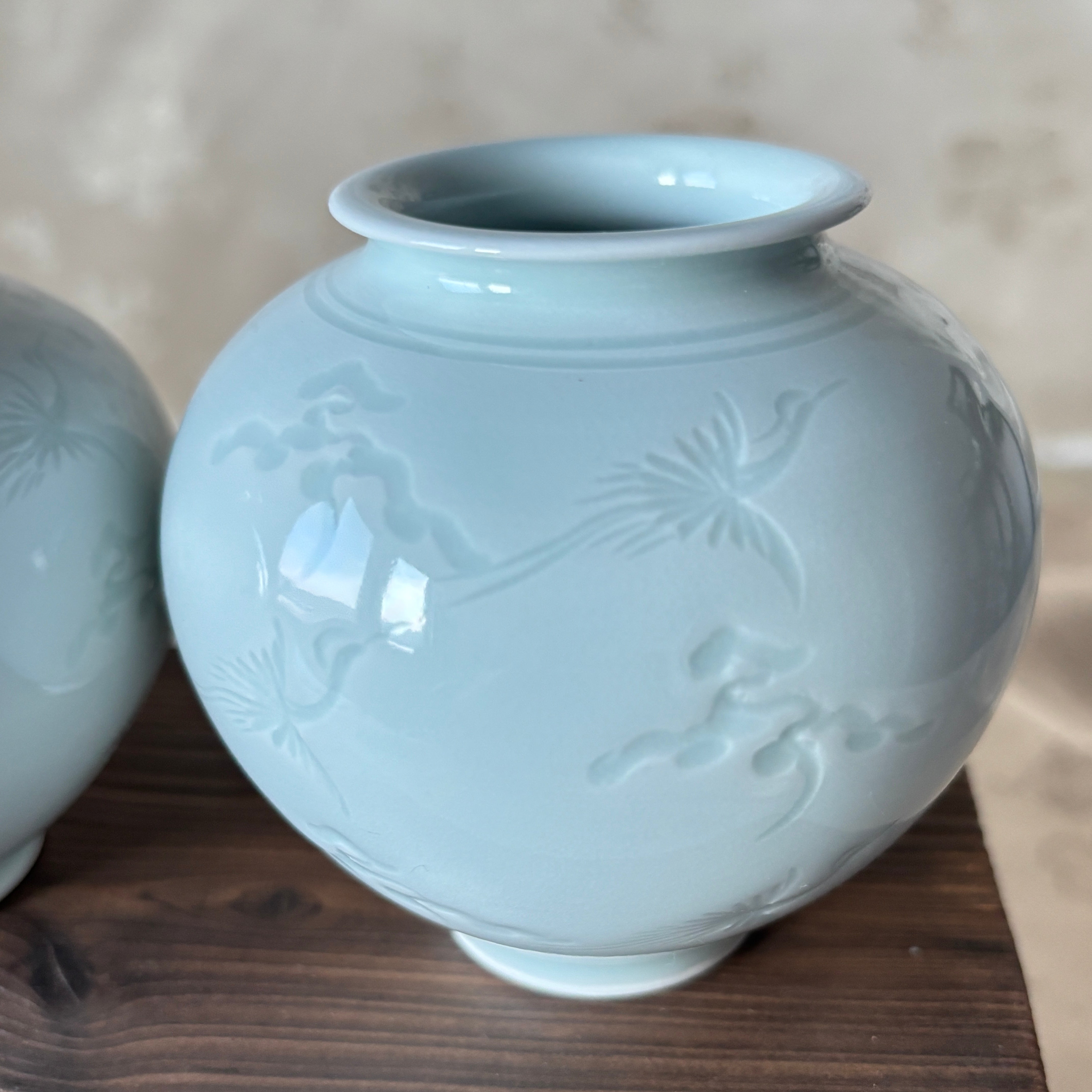 Ceramic vase with floral patterns on a wooden surface
