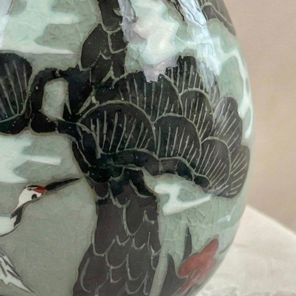 Decorative ceramic piece with black floral patterns on a light background