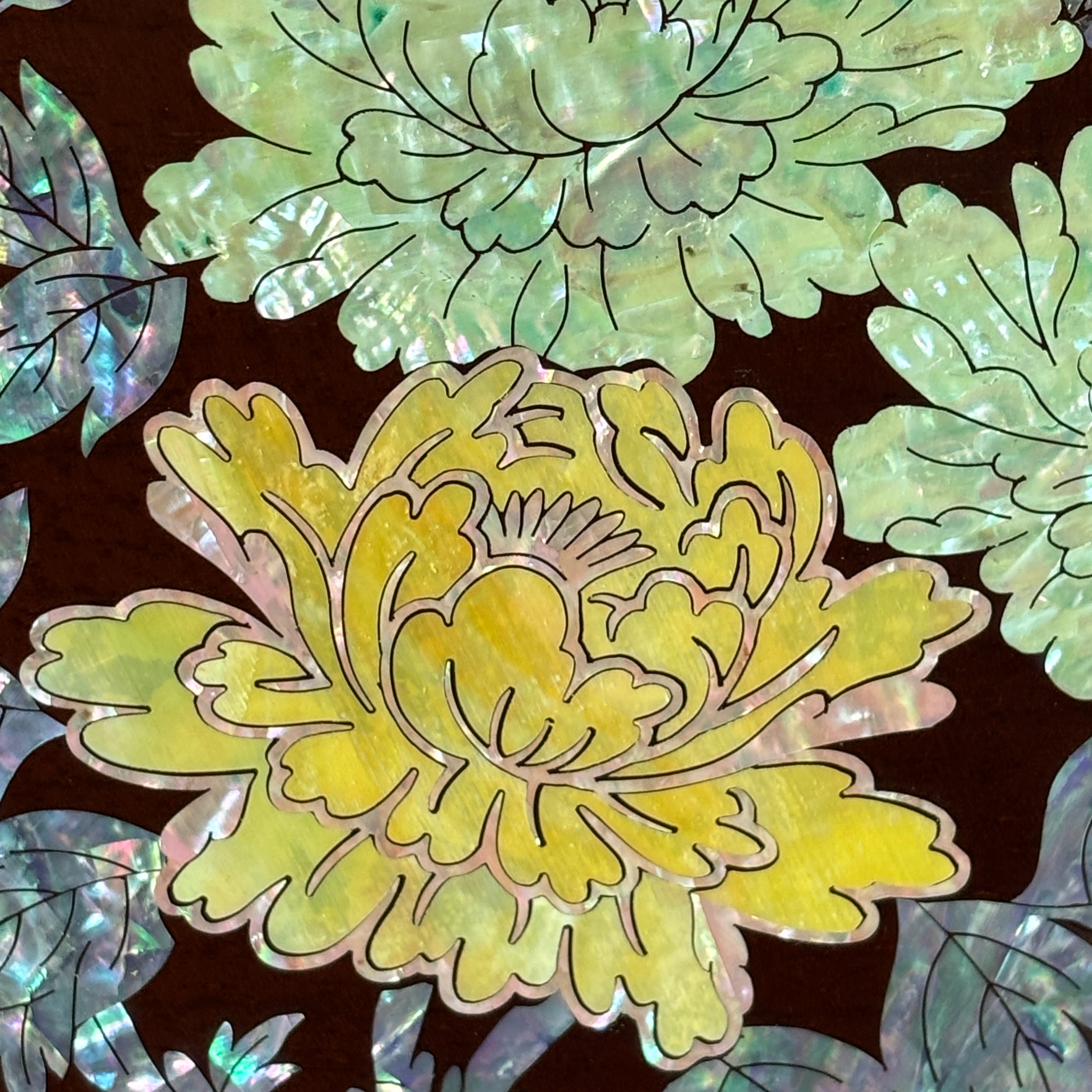 Decorative floral design with green and yellow flowers on a brown background