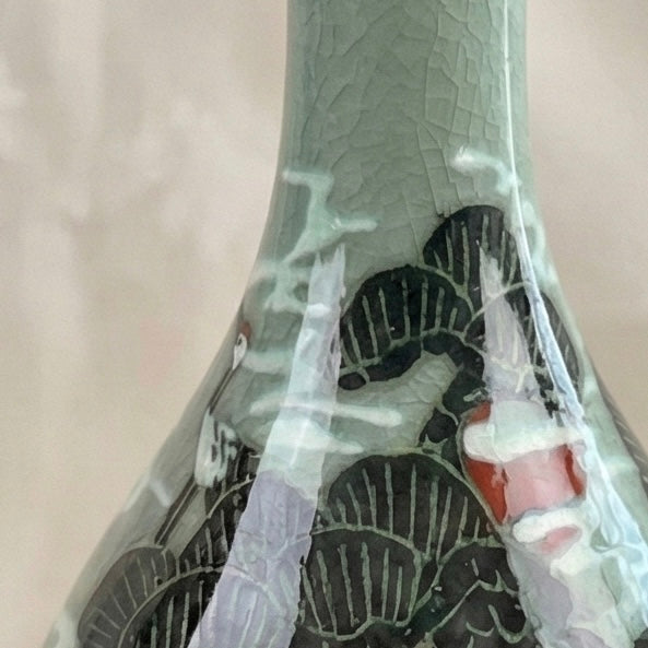 Decorative vase with intricate patterns on a light pink background