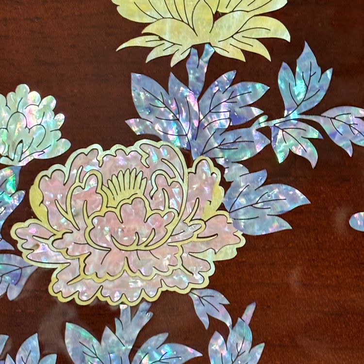 Iridescent floral and leaf designs on a brown background